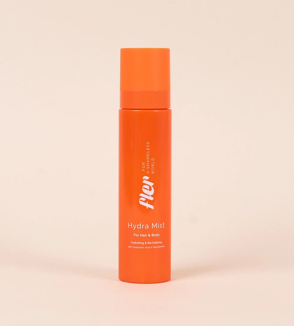 Orange bottle of 'Fler' Hydra Mist on a beige background